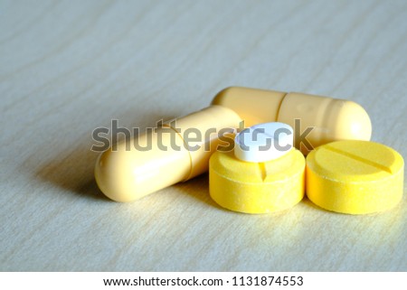 Antibiotic, paracetamol medicine on white wood