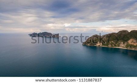 Aerial view of Phi Phi Islands, Thailand with cloudy sky and calm water