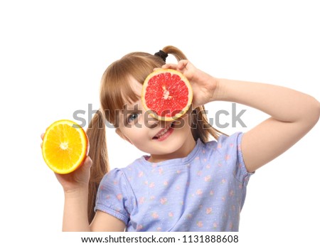 Cute little girl with citrus fruits on white background