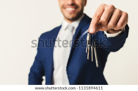 House keys in hands of businessman. Real estate concept, selective focus