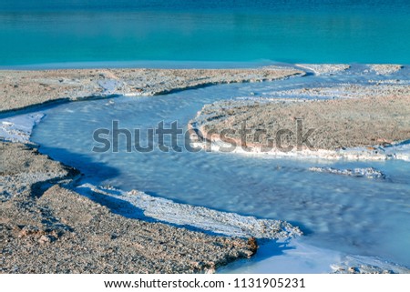 The river delta entering the turquoise lake