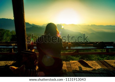 Tourists look at the morning sunrise at the northern Thai coffee shop, Chiang Mai, Thailand.