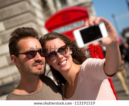 Couple taking a self portrait in the streets of London