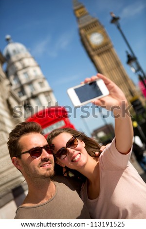 Tourists taking a picture in London with their phone