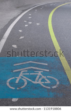 bicycle lane signage on street, cinematic tone filter