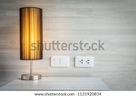 Yellow light decoration in bed room with switch and electric plug connector - bed room background concept Royalty-Free Stock Photo #1131920834