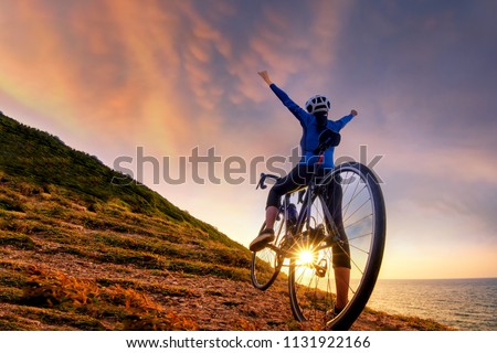 Mountain Bike cyclist standing on top of a mountain with bicycle .Extreme sport concept.