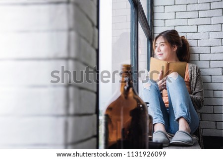 Relaxation with Book Concept. Soft Focus of Young Woman Spending Time to Reading in Cozy House, Nearby Window