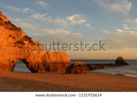 Sunset over cliffs at deserted beach (in Algarve, Portugal)