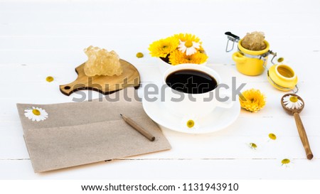 Blank Kraft Paper Page and Pencil for Message or Recipe with a Cup of Coffee and Summer Calendula and Chamomile Flowers