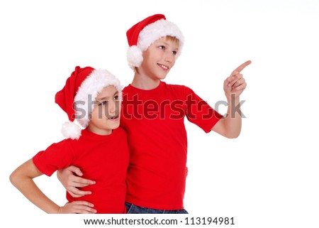 cute little brothers in santa hats on white