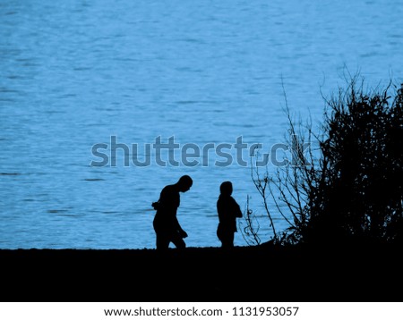 Female and male silhouettes on a blue background