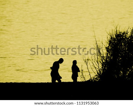 Female and male silhouettes on a yellow background