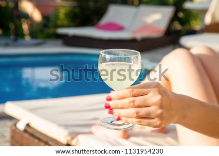 Summer day lifestyle woman relax near luxury swimming pool. Concept Summer
