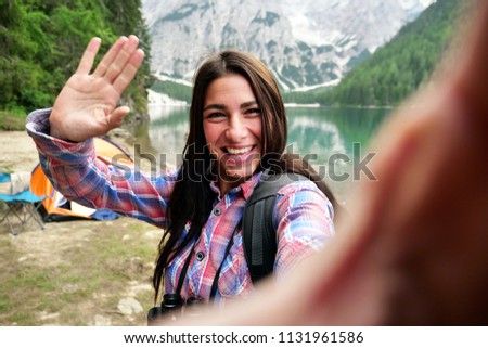 On holiday, A girl, in mountain, uses a telephone for take pictures, make selfies and video calls friends and family from home. Concept:holiday,technology,love,message