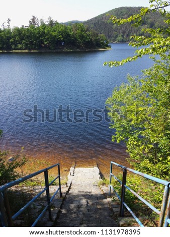 Stairs on the lake with clean water and mountain views ,Vodni nadrz Orlik nad Vltavou, Czech Republic, South Bohemia