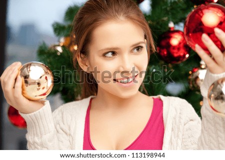 bright picture of woman decorating christmas tree.....