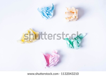 Crumpled colored paper on a white background, smooth blue sheet