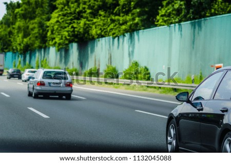 Germany Autobahn traffic: black car close-up at the blurred background 
