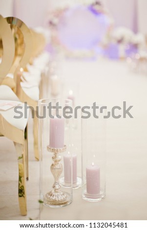 burning candles in glass vases