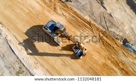 Aerial photo of a backhoe on a construction site, France