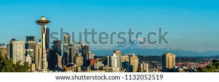 Seattle, Washington - USA. Wide panorama of sunset above Space Needle, with Mount Reinier in the background.