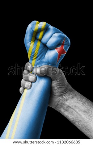 Fist painted in colors of Aruba flag, fist flag, country of Aruba
