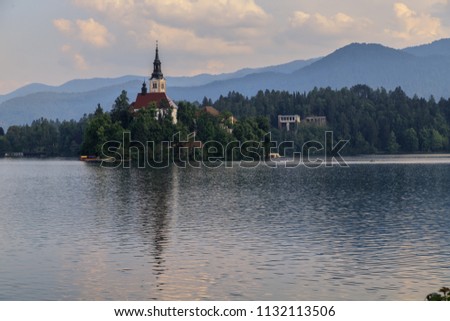 Amazing view of Bled Lake, Bled island with small pilgrimage Church of the Assumption of Maria, mountains on the background, Slovenia, Europe. Peace and quiet. Holidays in Slovenia.