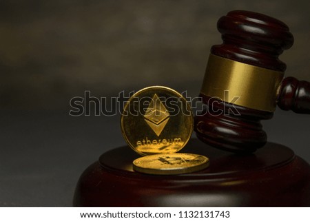 golden ethereum stand beside judge gavel