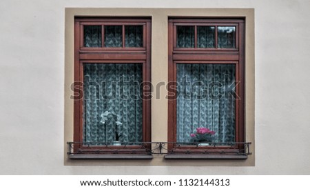 A window with wooden frame and decoration inside