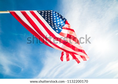 Close up United States of America flag on the blue sky background. USA Independence day, 4 July.