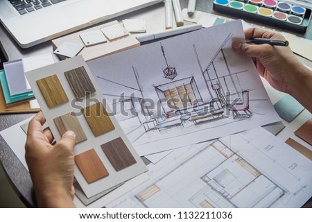 Architect designer Interior creative working hand drawing sketch plan blue print selection material color samples art tools Design Studio Royalty-Free Stock Photo #1132211036