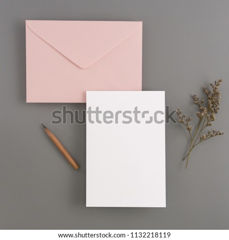 A wedding mock up concept. Wedding Invitation, envelopes, cards Papers on color background with ribbon and decoration. Top view, flat lay, copy space