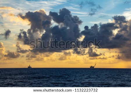 Area of work offshore on the high seas, the oil industry and a beautiful day and sunset