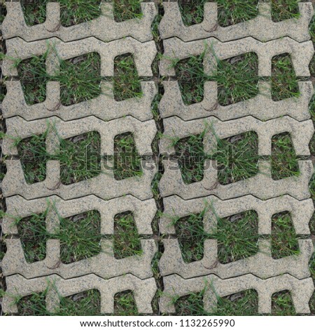 Seamless pattern with stone blocks of the original form on a park path covered and green grass Royalty-Free Stock Photo #1132265990
