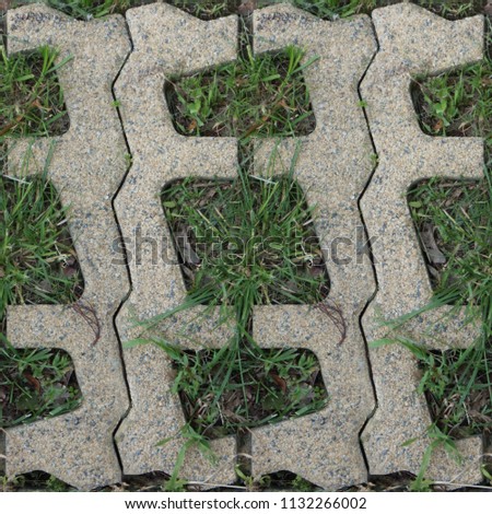Seamless pattern with stone blocks of the original form on a park path covered and green grass Royalty-Free Stock Photo #1132266002