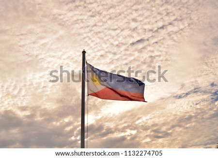 Philippine flag under cirrocumulus clouds.