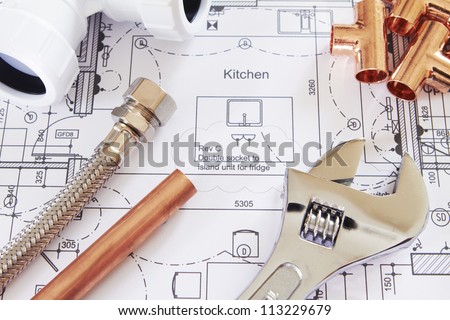 Plumbing Tools Arranged On House Plans Royalty-Free Stock Photo #113229679