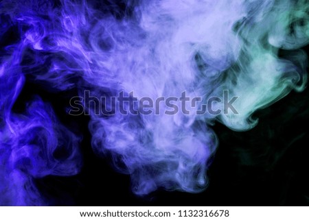 Thick  blue colorful smoke on a black isolated background. Background from the smoke of vape
