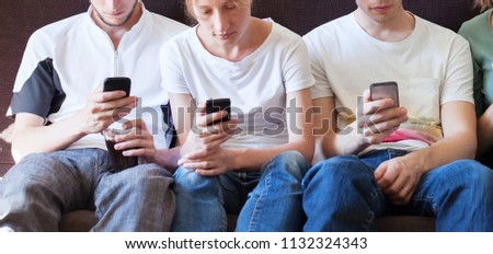 internet addiction, group of young people looking at their smartphones, close up of hands