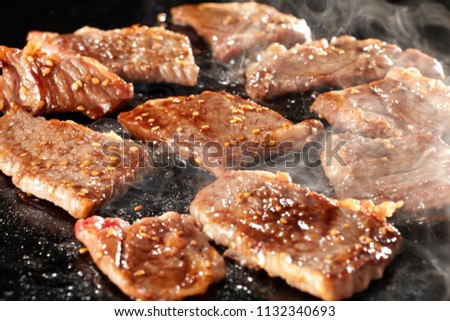 Yakiniku is the food that grille a thin sliced beef and dipped in a soy-bean sauce based sauce Royalty-Free Stock Photo #1132340693