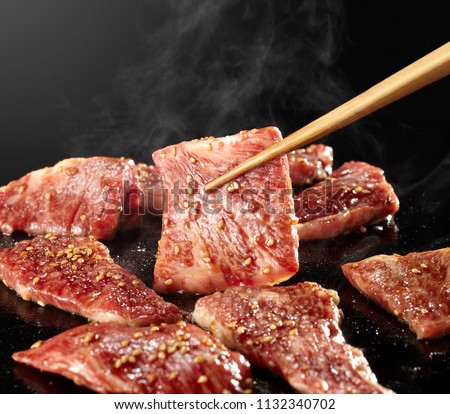 Yakiniku is the food that grille a thin sliced beef and dipped in a soy-bean sauce based sauce Royalty-Free Stock Photo #1132340702