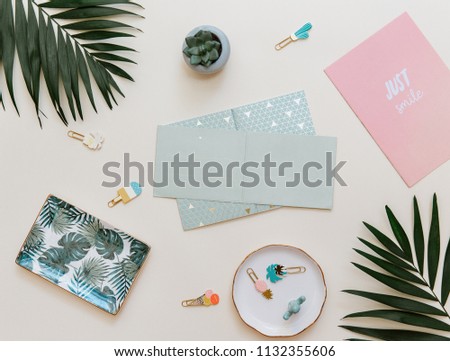 Creative layout with empty card tropical leaf on pastel background. Top view, flat lay 