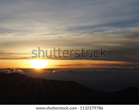 Amazing landscape of Mountain Sunset. Rays of the Sun against the Sky with colorful clouds. Contrast picture.