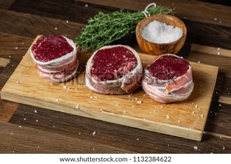 Craft selected beef steak marble meat for cooking fillet mignon in bacon. wooden background.