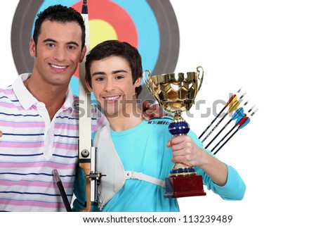 little boy winning an archery contest Royalty-Free Stock Photo #113239489