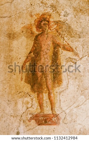 fresco on the wall of the god Mercury in a house of the ancient Pompeii that was buried by the eruption of the volcano Vesuvius in Italy