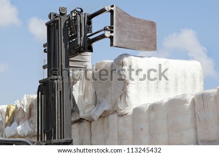 Forklift loading the bales of coton in a truck (TIR)  - Cotton bales, ready for delivery to cotton buyers.
