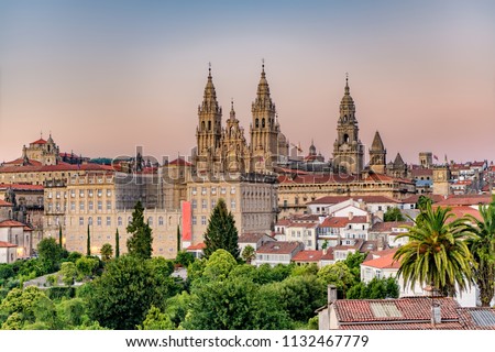 Hazy sunset on monumental Santiago de Compostela cathedral and cityscape. Royalty-Free Stock Photo #1132467779