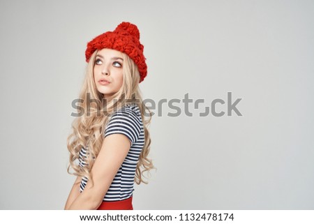   woman in red hat on light background                             
